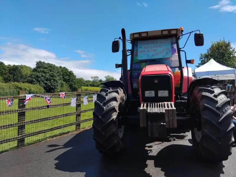 Tractor with balloons at a school fair: Swipe To View More Images